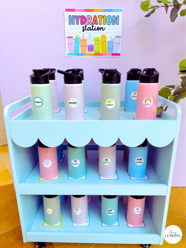Labeled water bottles organized by student name on a blue rolling classroom cart under a Hydration Station sign. Easy classroom setup ideas.