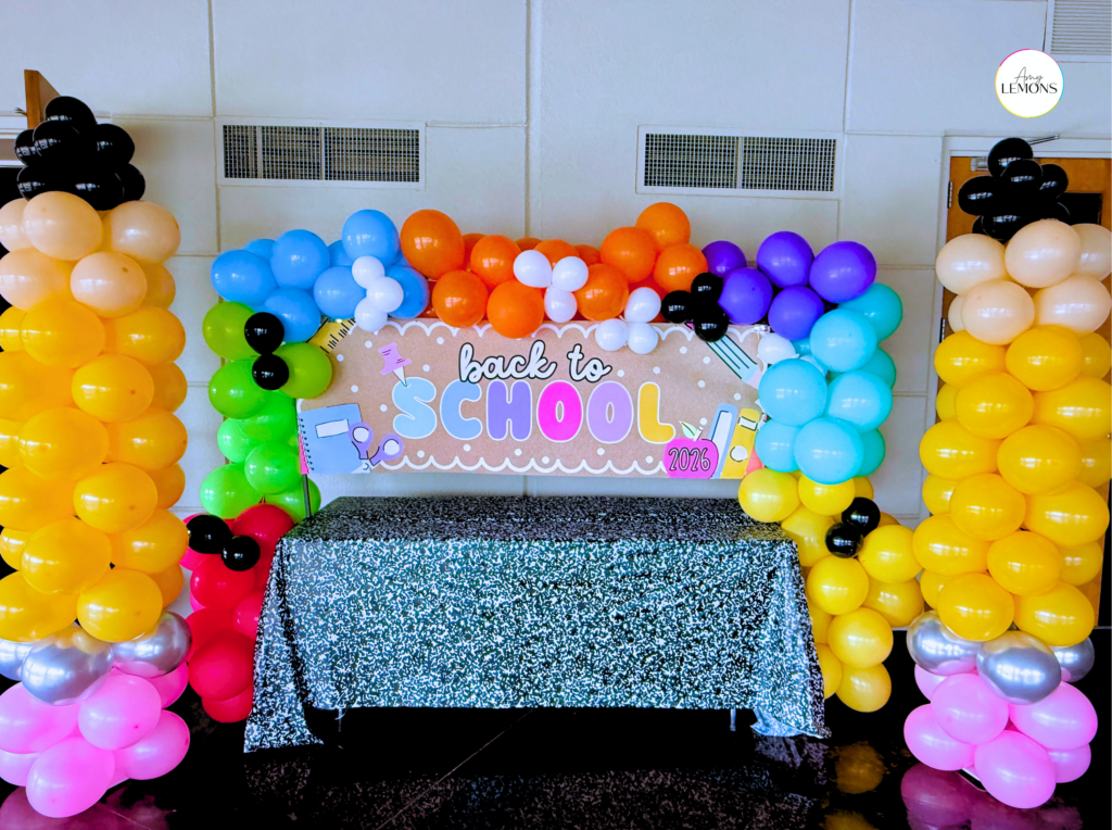 Colorful balloon columns framing a DIY back to school photo station