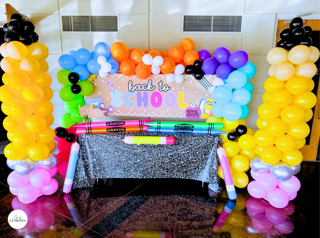 Finished back to school photo backdrop with balloons and banner for first day pictures