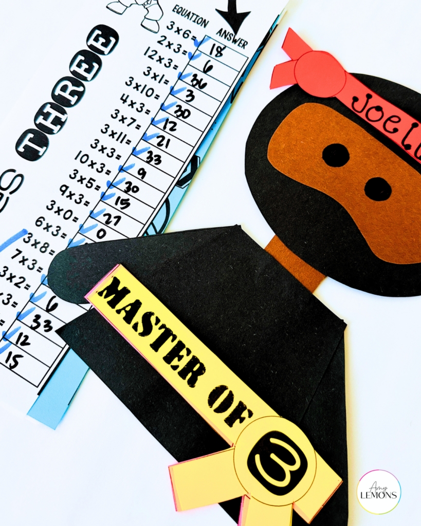 Fact Master Ninja craft with a Master of 3 belt next to a completed multiplication by three timed test