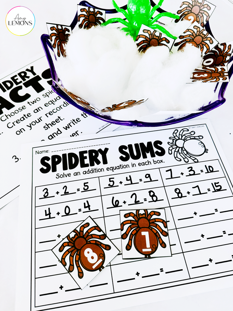 Spidery Sums addition recording sheet with completed equations and two numbered spider cards for a Halloween math center